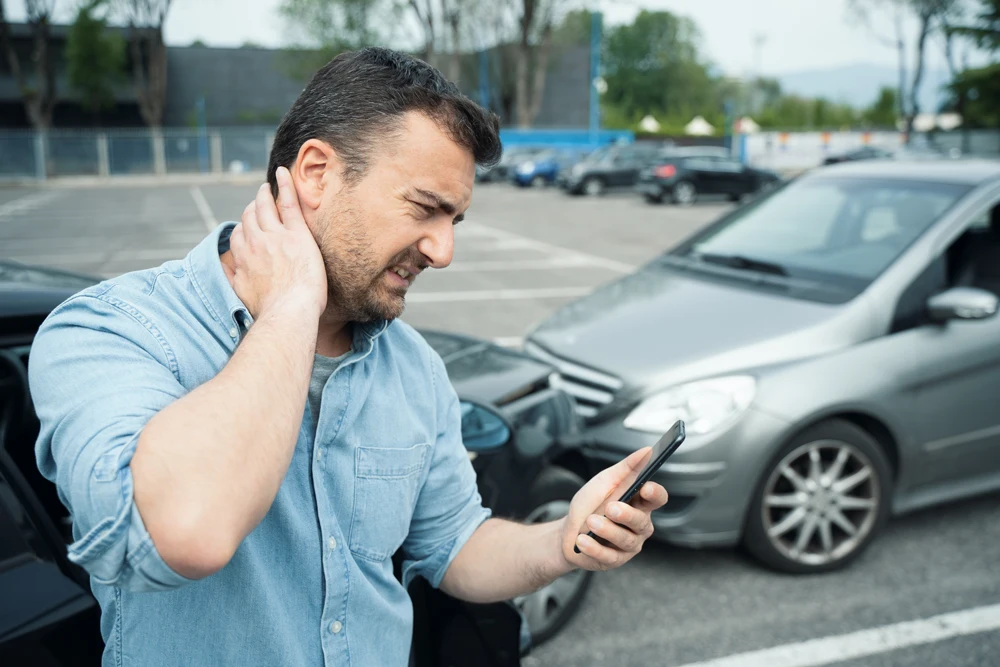 One man suffering pain after car crash injury calling first aid emergency