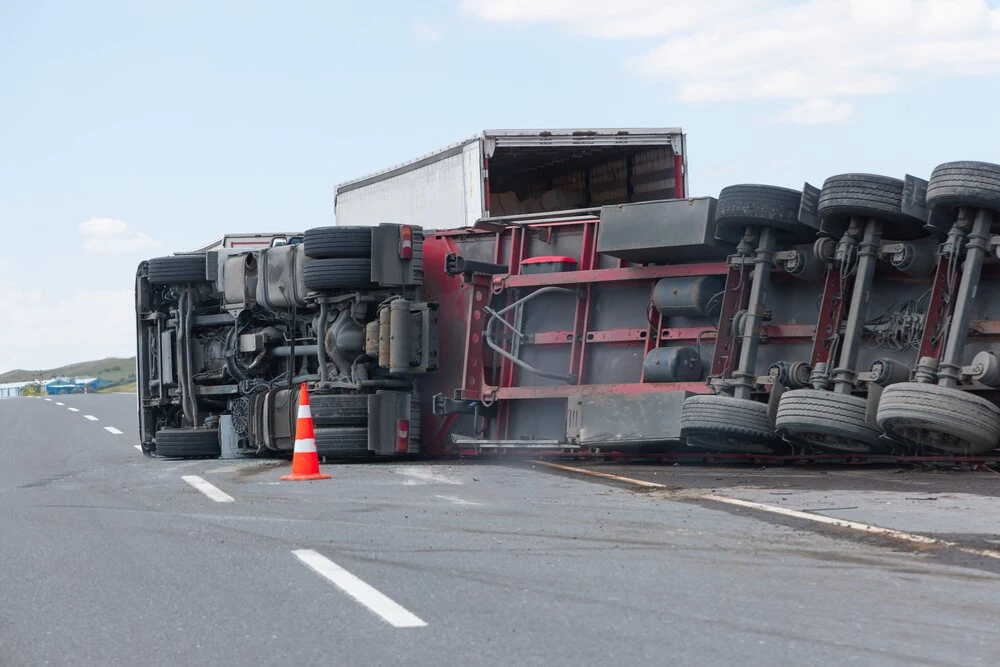An overloaded and fast truck (TIR) overturned on an interurban road